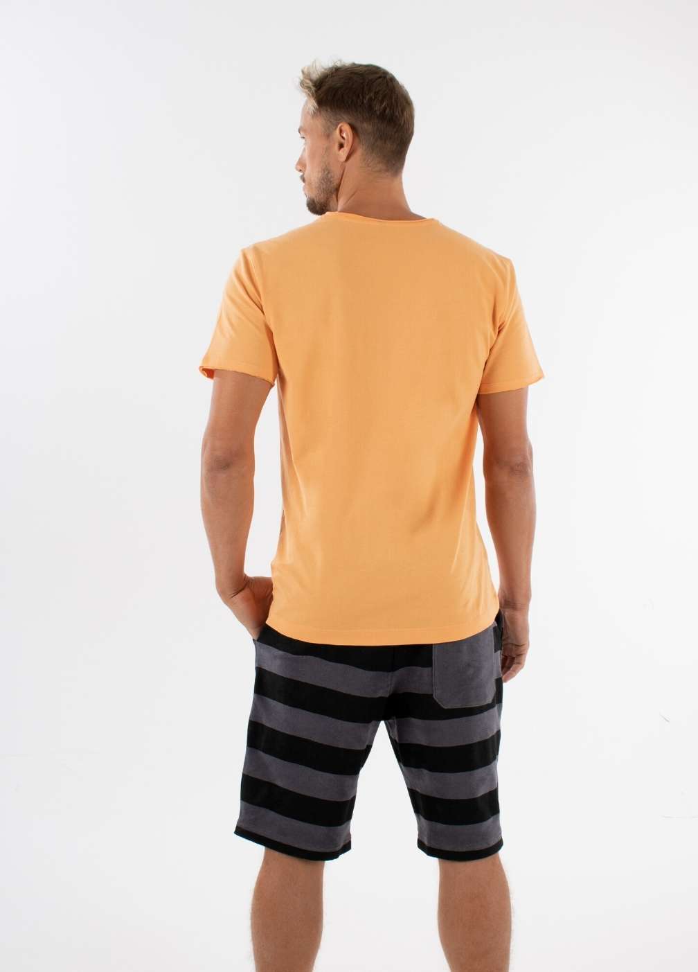nuffinz GOLD EARTH T-SHIRT PURE - whole outfit visible from the back - sustainable men's t shirts - orange
